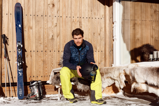 a man wearing skiiing equipment sat down