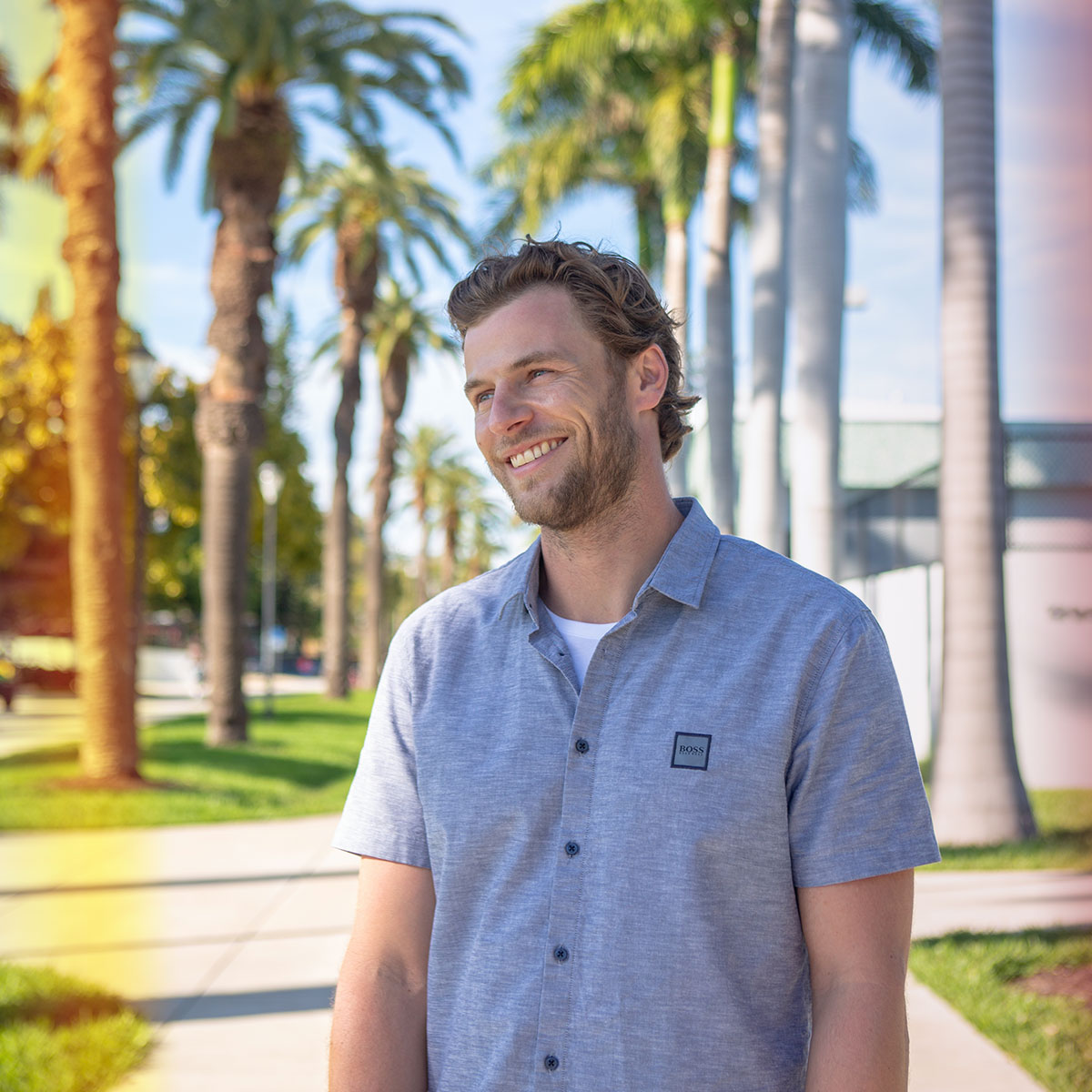 Man smiling wearing a hugo boss short sleeve shirt