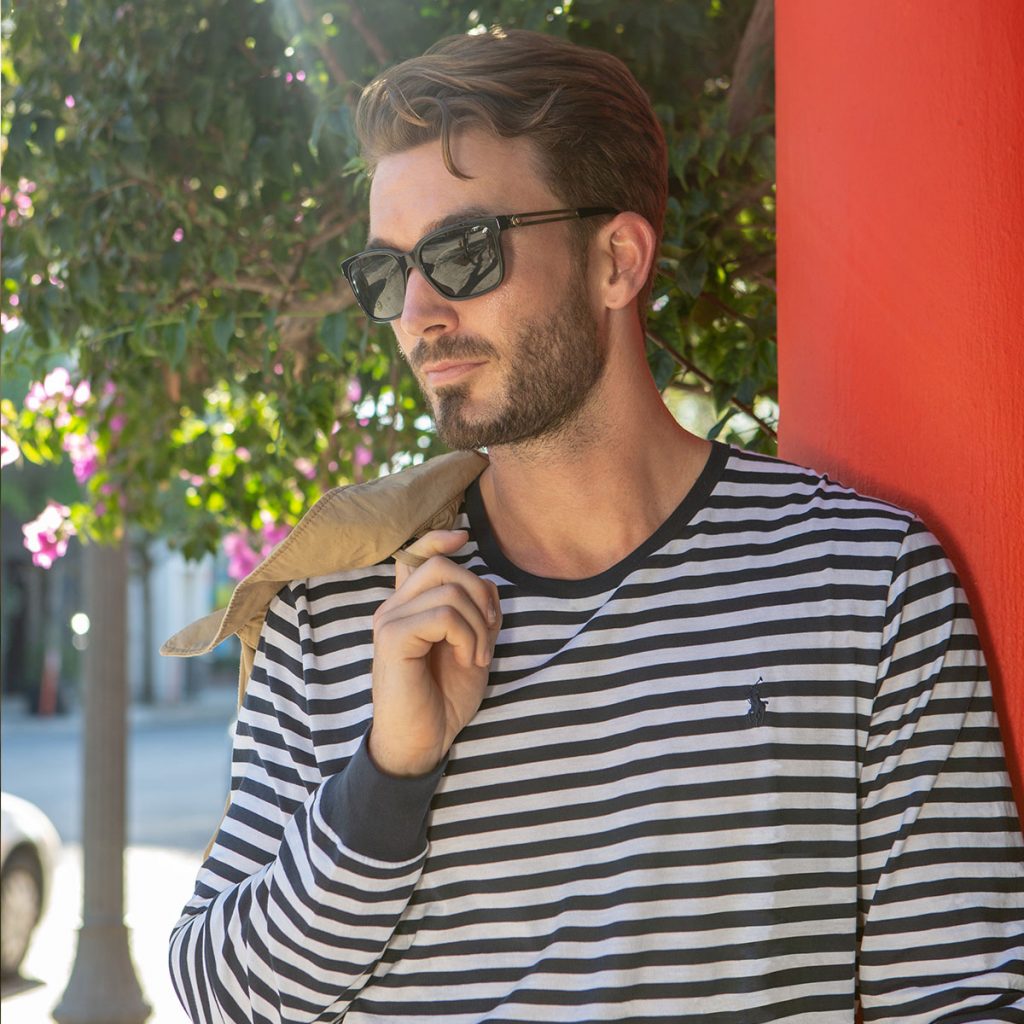 A man wearing a black and white striped Ralph Lauren shirt