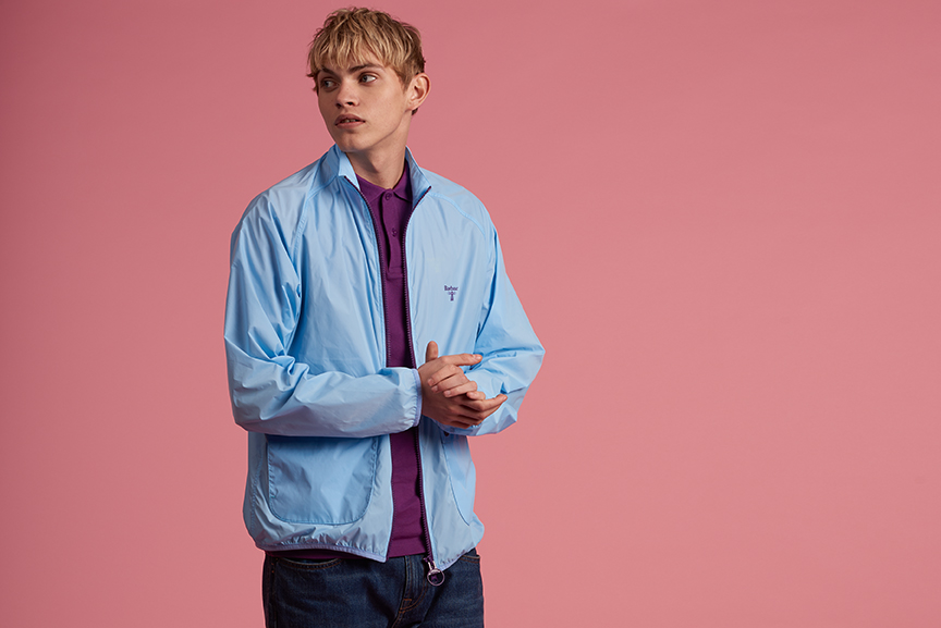 A blonde man wearing a light blue coat