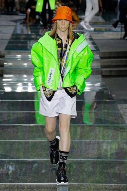 man wearing a neon green Versace coat on the runway at Versace Spring/Summer 2019 Menswear fashion event 